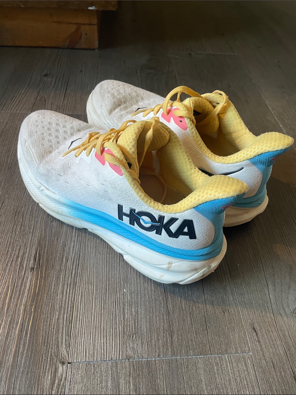 Hoka Womens Clifton 9 White Sneakers with Yellow Lining and Blue